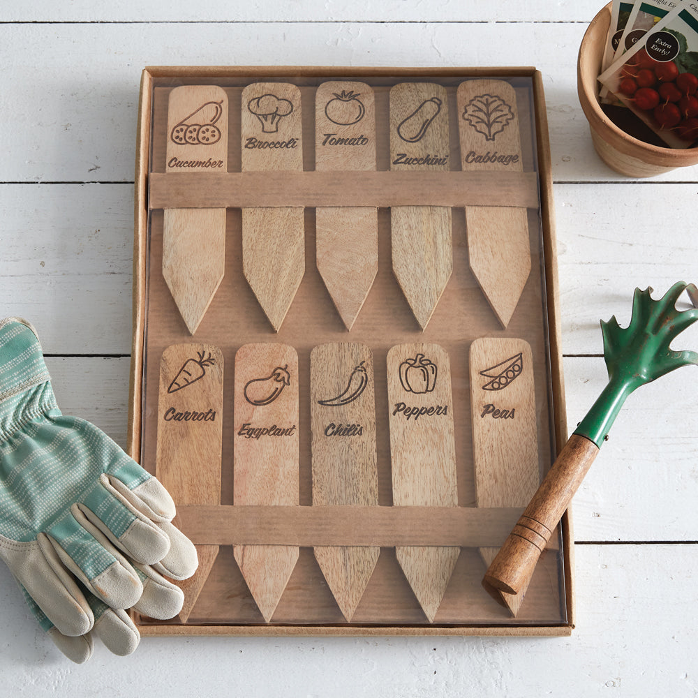 Wooden vegetable markers with designs of cucumber, broccoli, tomato, and more, beautifully packaged for gardening enthusiasts.