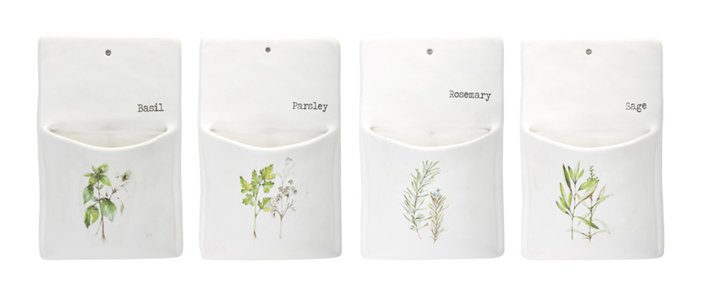 Four white pouches with herb illustrations and labels on a white background