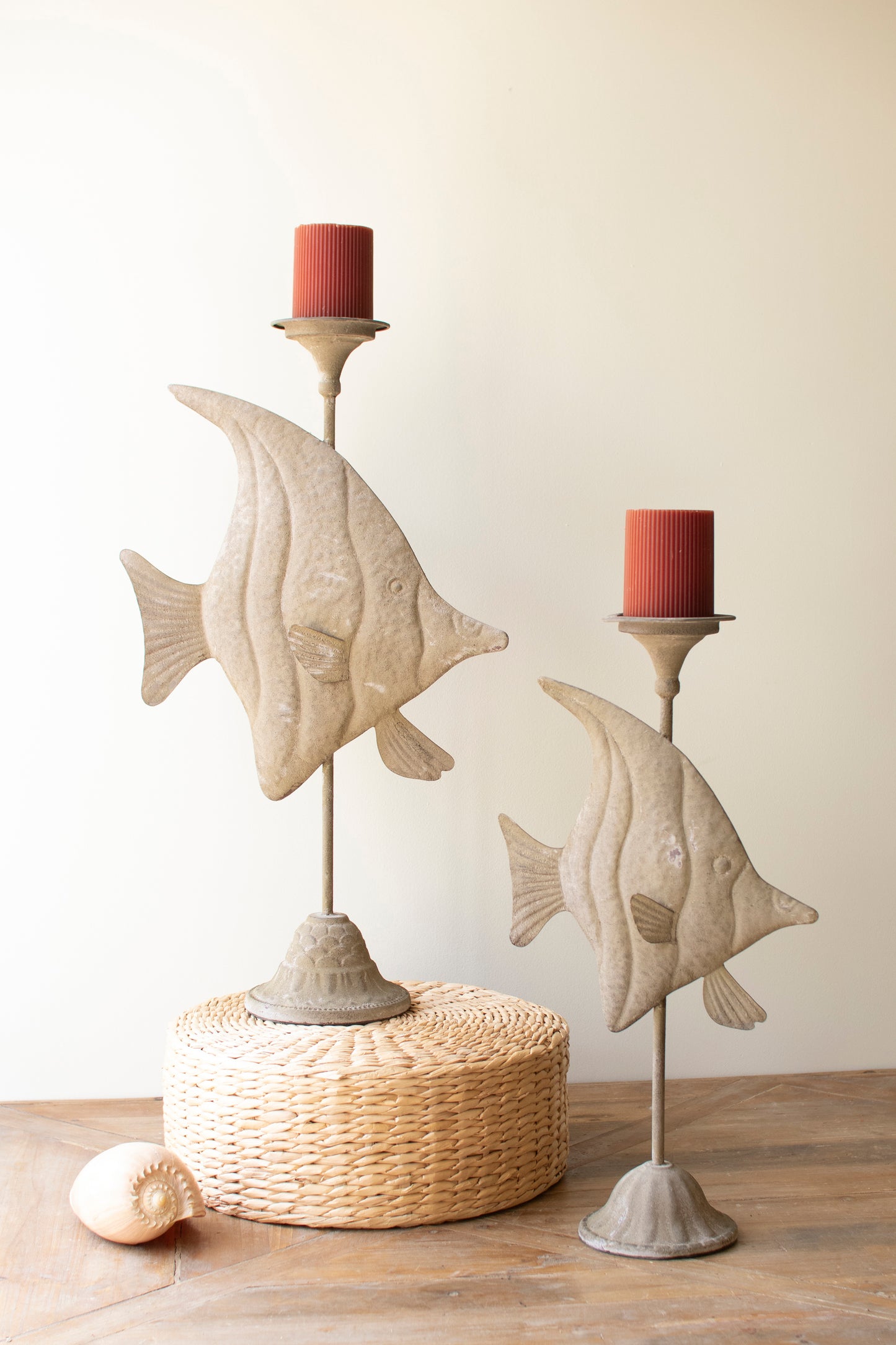 Two antique green fish with a distressed finish and intricate carvings, adding coastal charm to a shelf or tabletop.