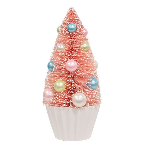 Pink Bottle Brush Tree with faux snow, pastel baubles in blue, pink, green, white on a pleated white base for festive decor.