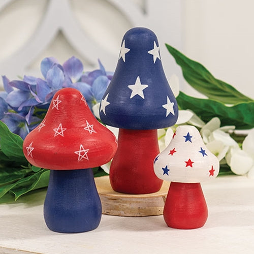 Set of 3 wooden Americana mushroom sitters with painted red, white, and blue patriotic details