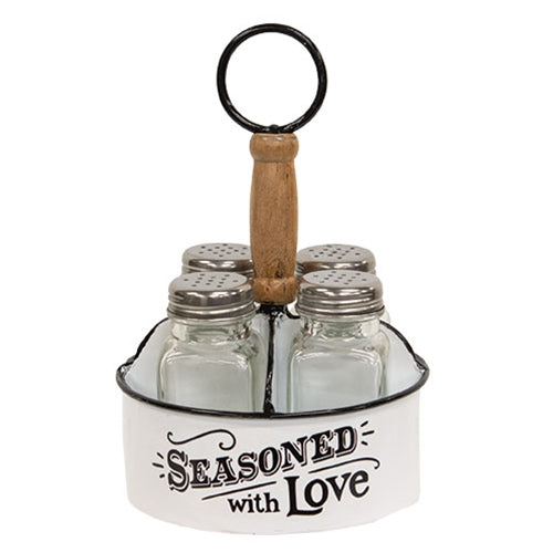 Rustic white metal seasoning caddy with wood handle and four glass shakers, featuring “seasoned with love” lettering