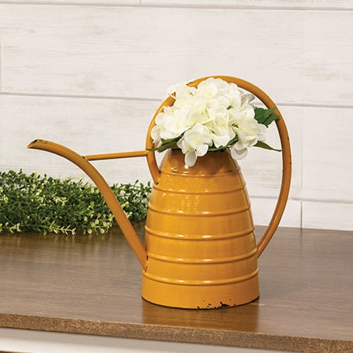Distressed mustard metal beehive watering can with weathered finish and wraparound handle, rustic farmhouse decor