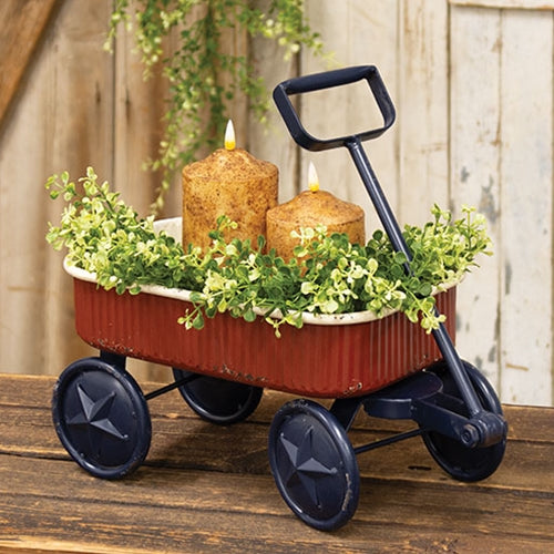 Rustic distressed metal wagon in deep red, cream, and navy with star accents, perfect for farmhouse Americana decor.