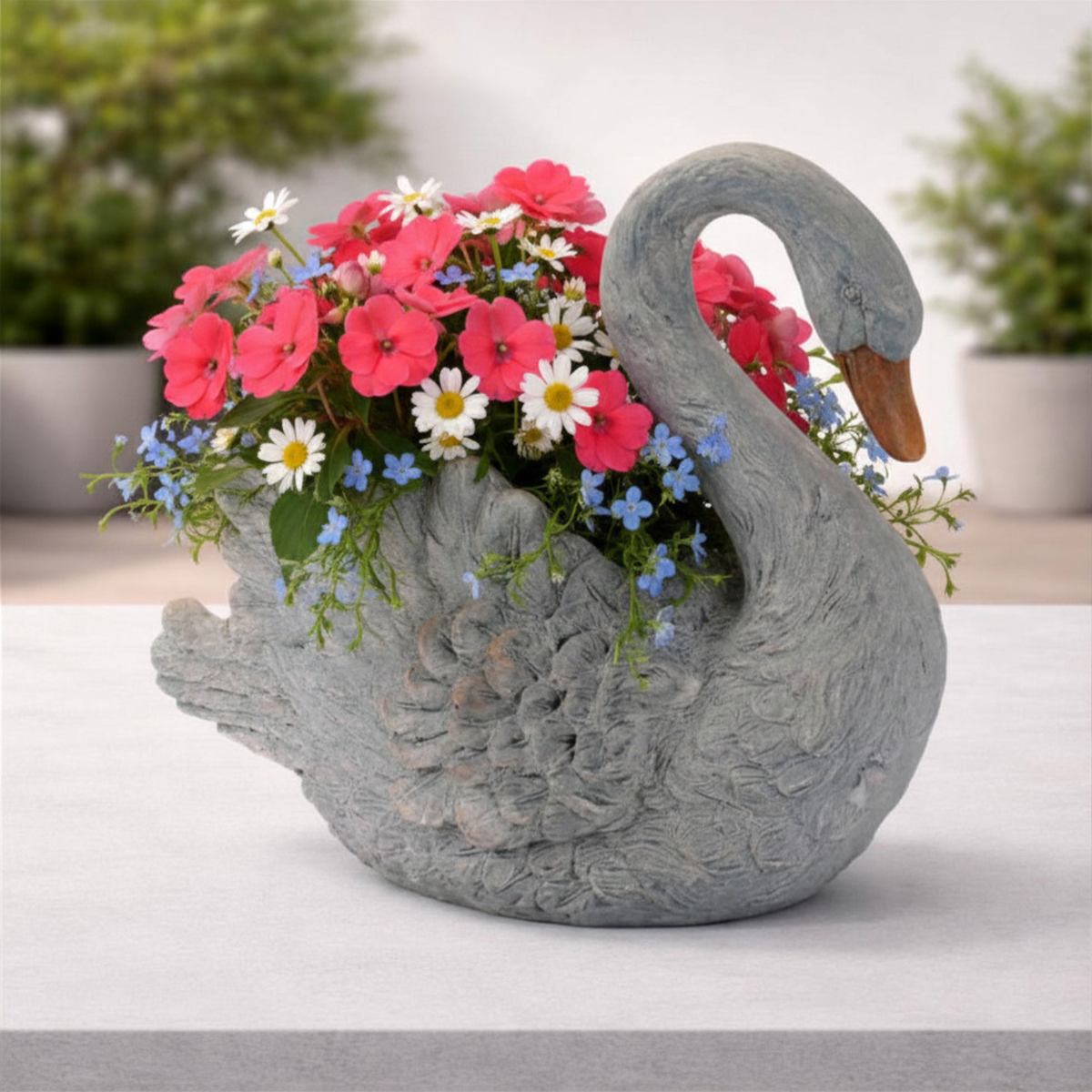 Graceful white swan planter with feathered details and curved neck for indoor or patio decor