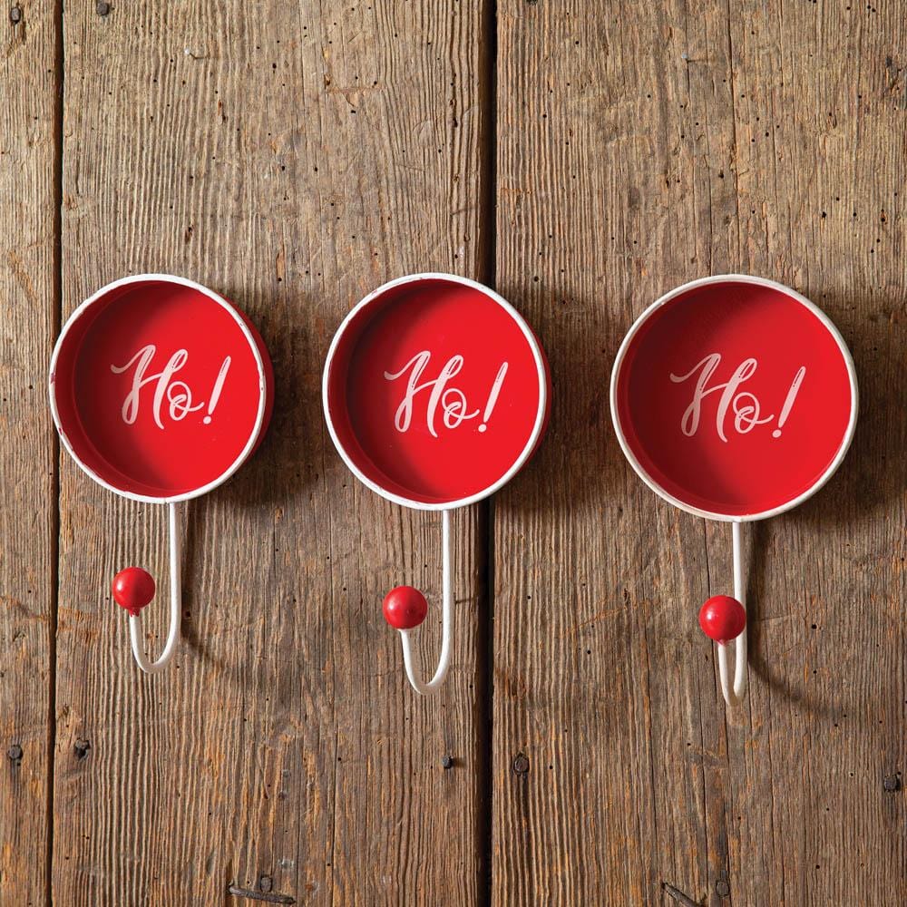 Festive wall hooks set with "Ho! Ho! Ho!" design, perfect for hanging stockings and ornaments, adding charm to holiday decor.