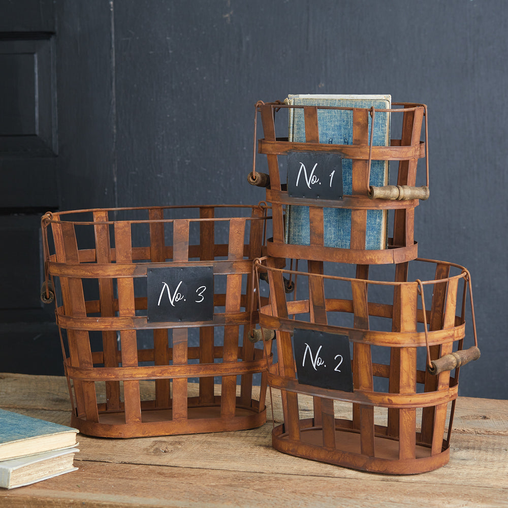 Set of three rustic baskets with antique metal finish, numbered 1 to 3, perfect for adding vintage charm to any decor.