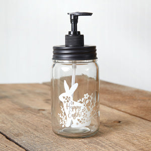 Easter-themed soap dispenser with a cute bunny, "Happy Easter" text, floral accents, clear glass body, and black pump.