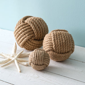 Set of three nautical rope balls in varying sizes, crafted from natural materials, displayed in a decorative arrangement.