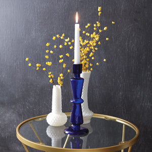 Cobalt blue glass taper candle holder with elegant design, perfect for enhancing dining decor; candles not included.