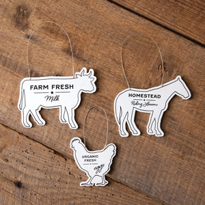 Set of three wooden farm animal ornaments: rooster with "organic fresh eggs," cow with "farm fresh milk," horse with "homestead riding lessons."
