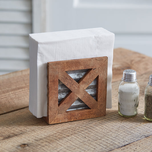 Barn door motif napkin holder made of wood and galvanized metal, adding rustic elegance and farmhouse charm to any table setting.