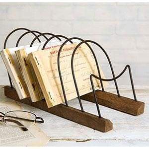 Wooden letter holder with metal loops, elegantly organizing papers on a desk, enhancing workspace style and efficiency.