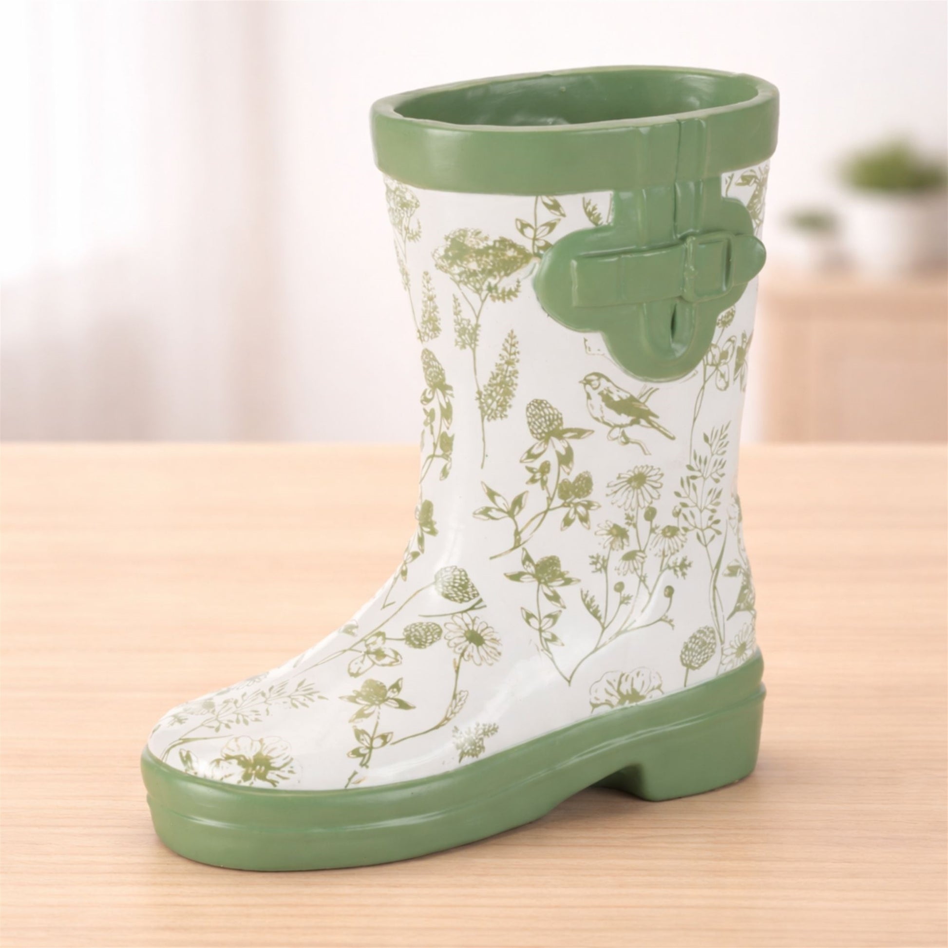 White rain boot vase with green botanical bird details and buckle accents, perfect for farmhouse decor and flowers