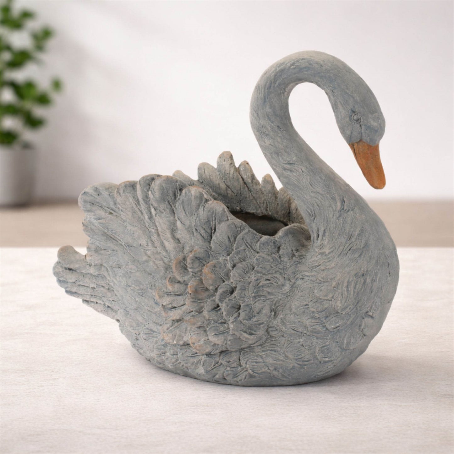 Graceful white swan planter with feathered details and curved neck for indoor or patio decor