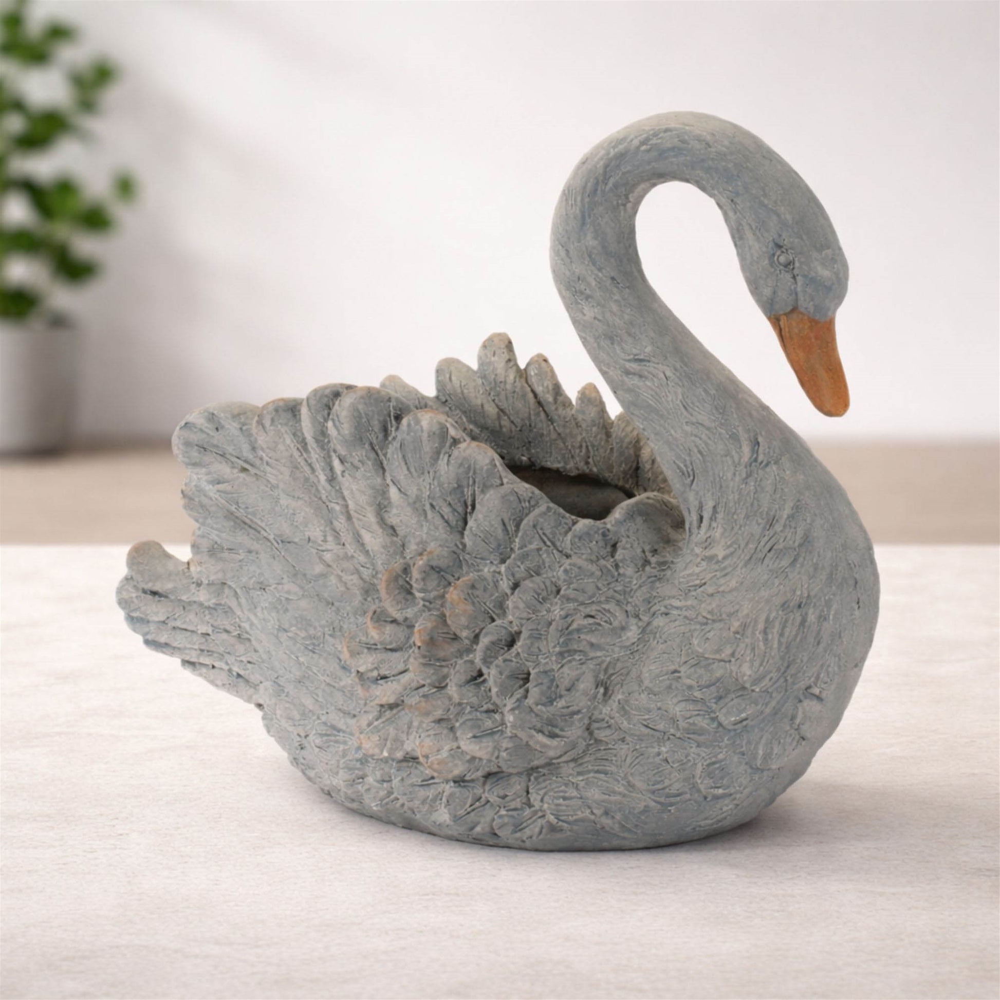 Graceful white swan planter with feathered details and curved neck for indoor or patio decor