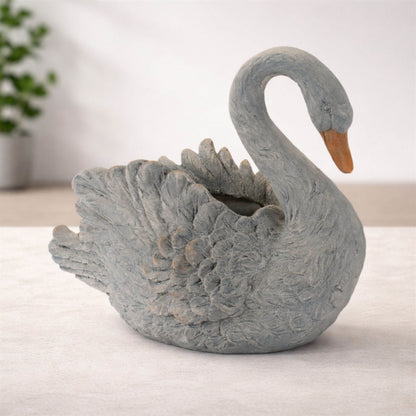 Graceful white swan planter with feathered details and curved neck for indoor or patio decor