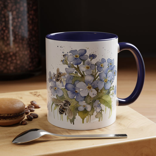 Botanical bee floral ceramic mug with soft blue flowers, tiny bees, navy handle, and cozy handcrafted look.