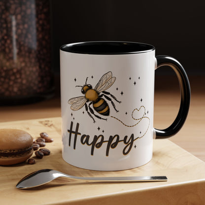 Bee Happy glazed ceramic mug with bee design, soft gold accents, and black handle and inside.