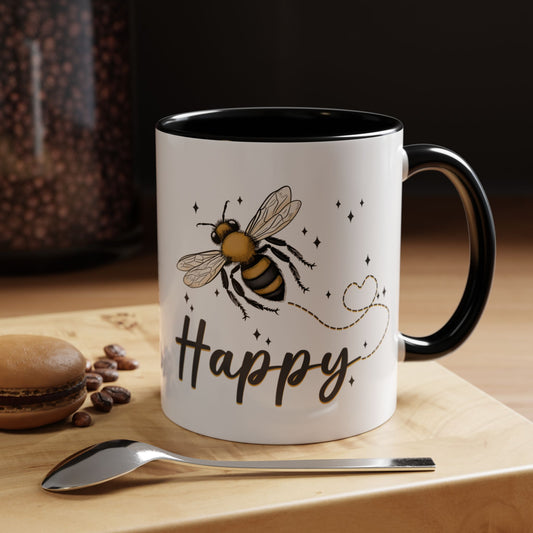 Bee Happy glazed ceramic mug with bee design, soft gold accents, and black handle and inside.
