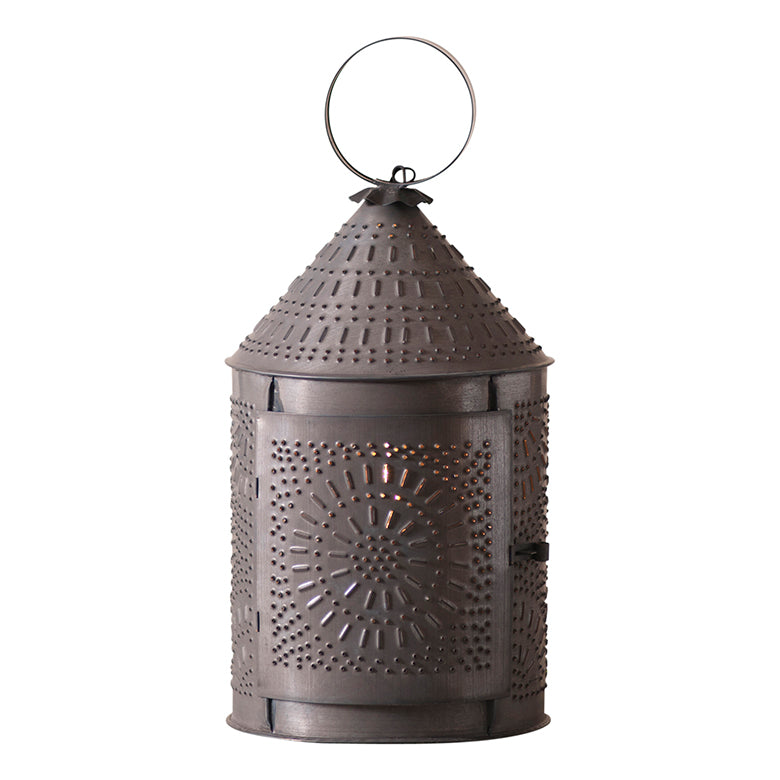 Revere Lantern with intricate punch pattern casting a warm glow, enhancing home decor with charm and ambiance.