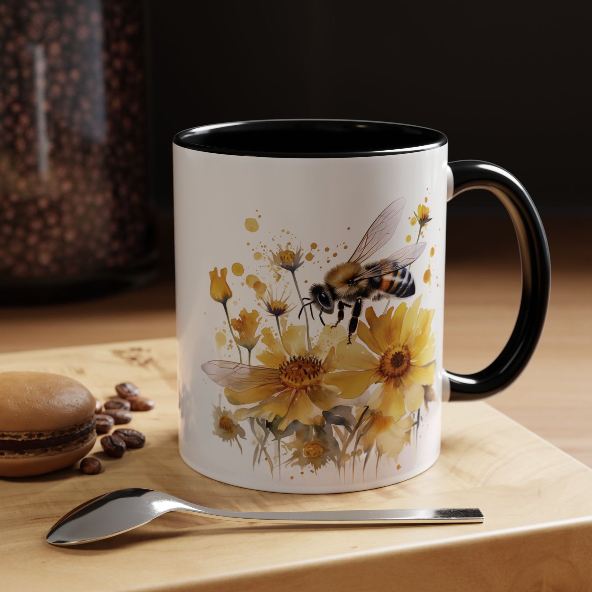 White ceramic mug with black handle and golden bee wildflower watercolor design