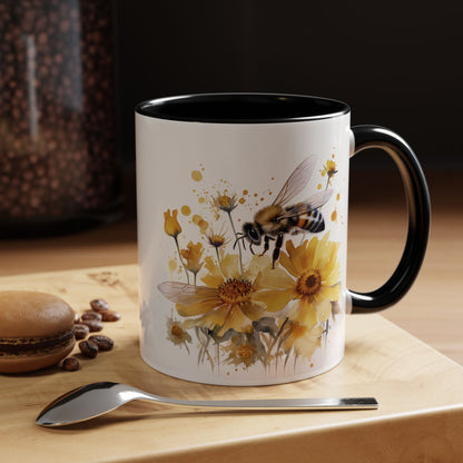 White ceramic mug with black handle and golden bee wildflower watercolor design