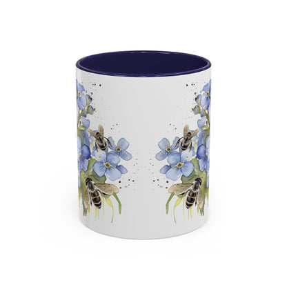 Botanical bee floral ceramic mug with soft blue flowers, tiny bees, navy handle, and cozy handcrafted look.