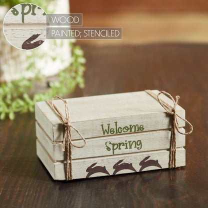 Cream faux book stack decor with Welcome Spring text, hand-painted bunnies, and soft farmhouse spring charm.