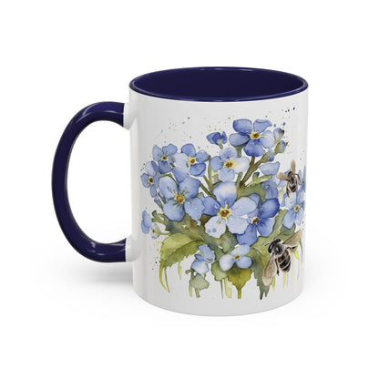 Botanical bee floral ceramic mug with soft blue flowers, tiny bees, navy handle, and cozy handcrafted look.