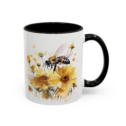 White ceramic mug with black handle and golden bee wildflower watercolor design