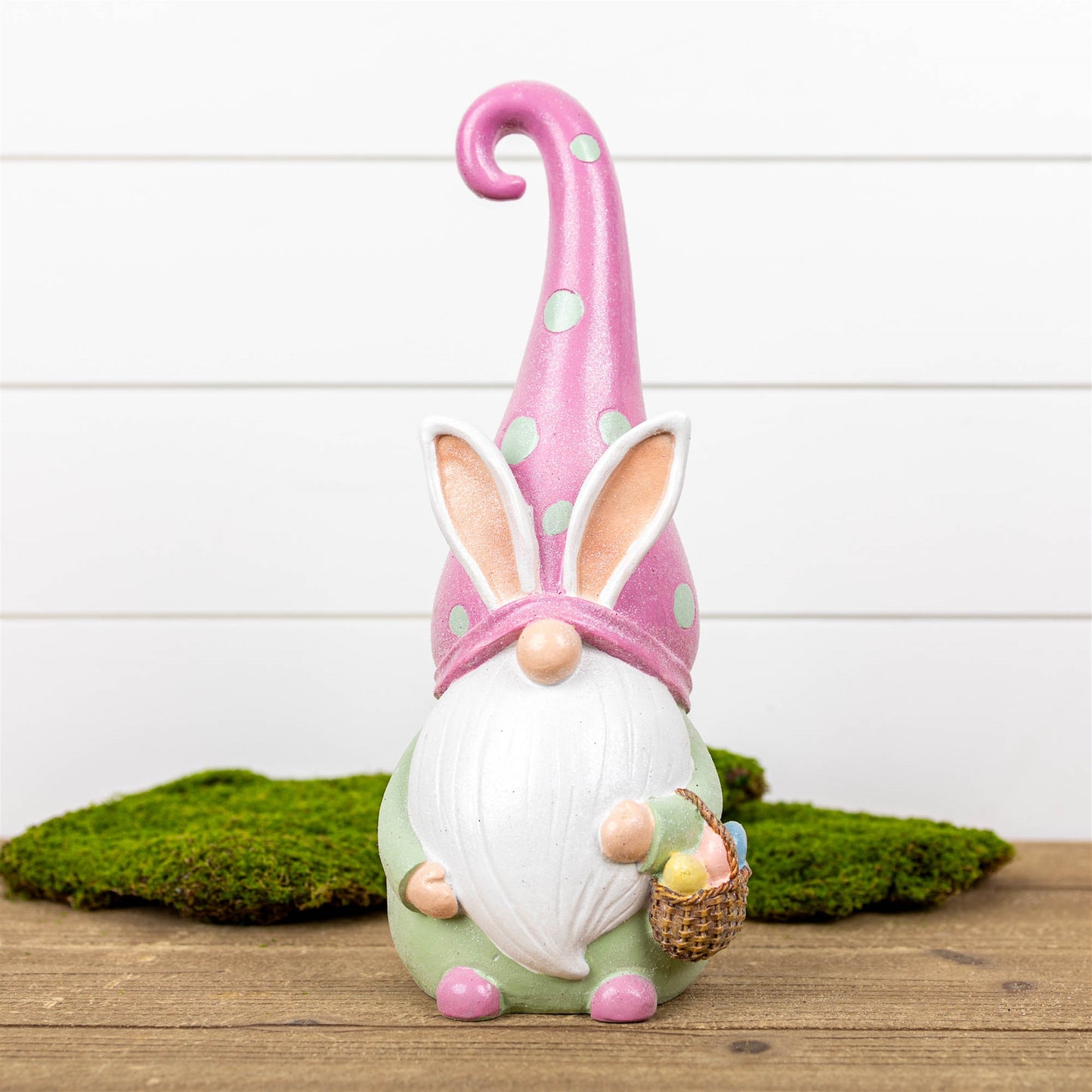 Easter Gnome Figurine in pastel pink with a charming basket, crafted from polyresin, perfect for festive spring decor.