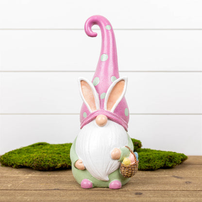 Easter Gnome Figurine in pastel pink with a charming basket, crafted from polyresin, perfect for festive spring decor.