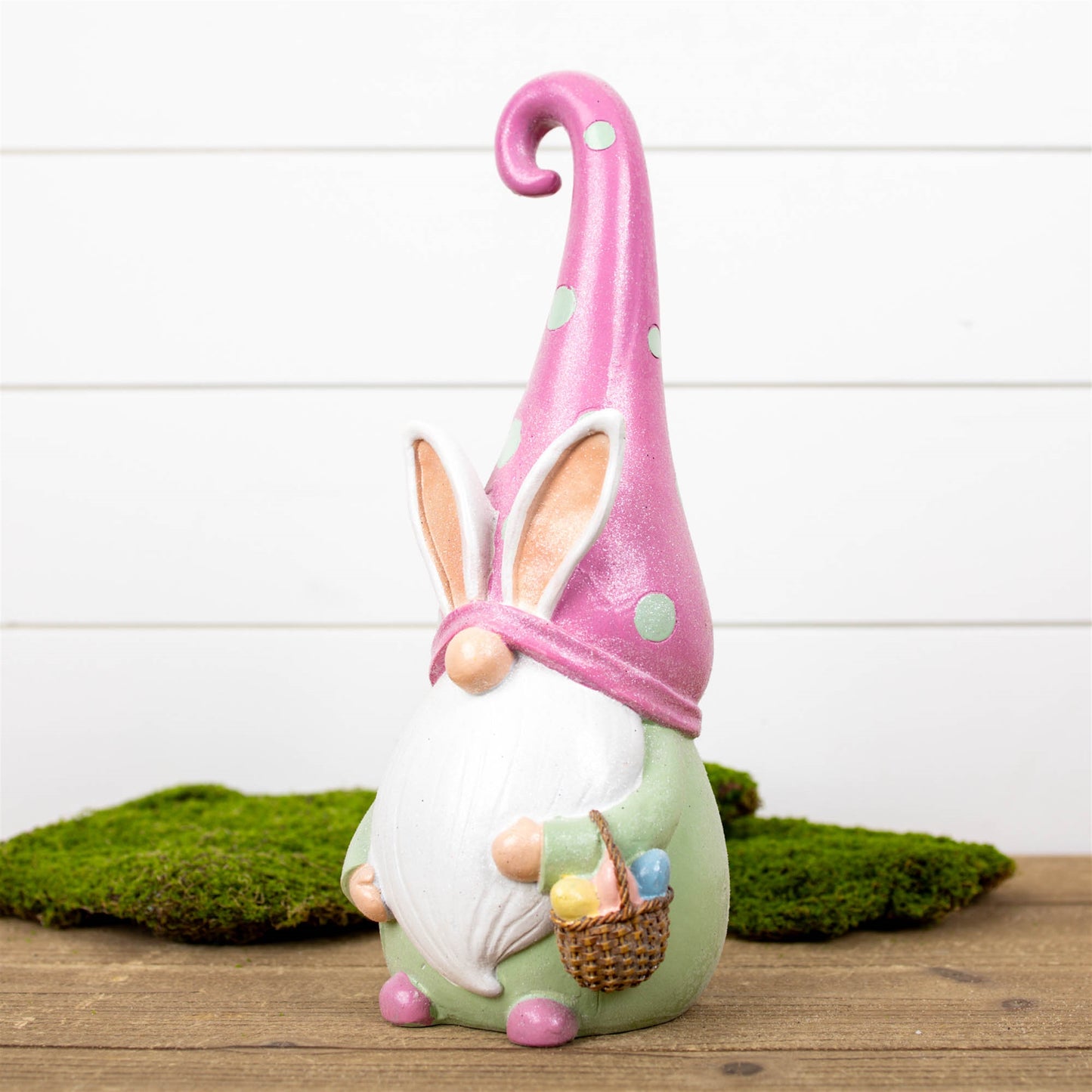 Easter Gnome Figurine in pastel pink with a charming basket, crafted from polyresin, perfect for festive spring decor.
