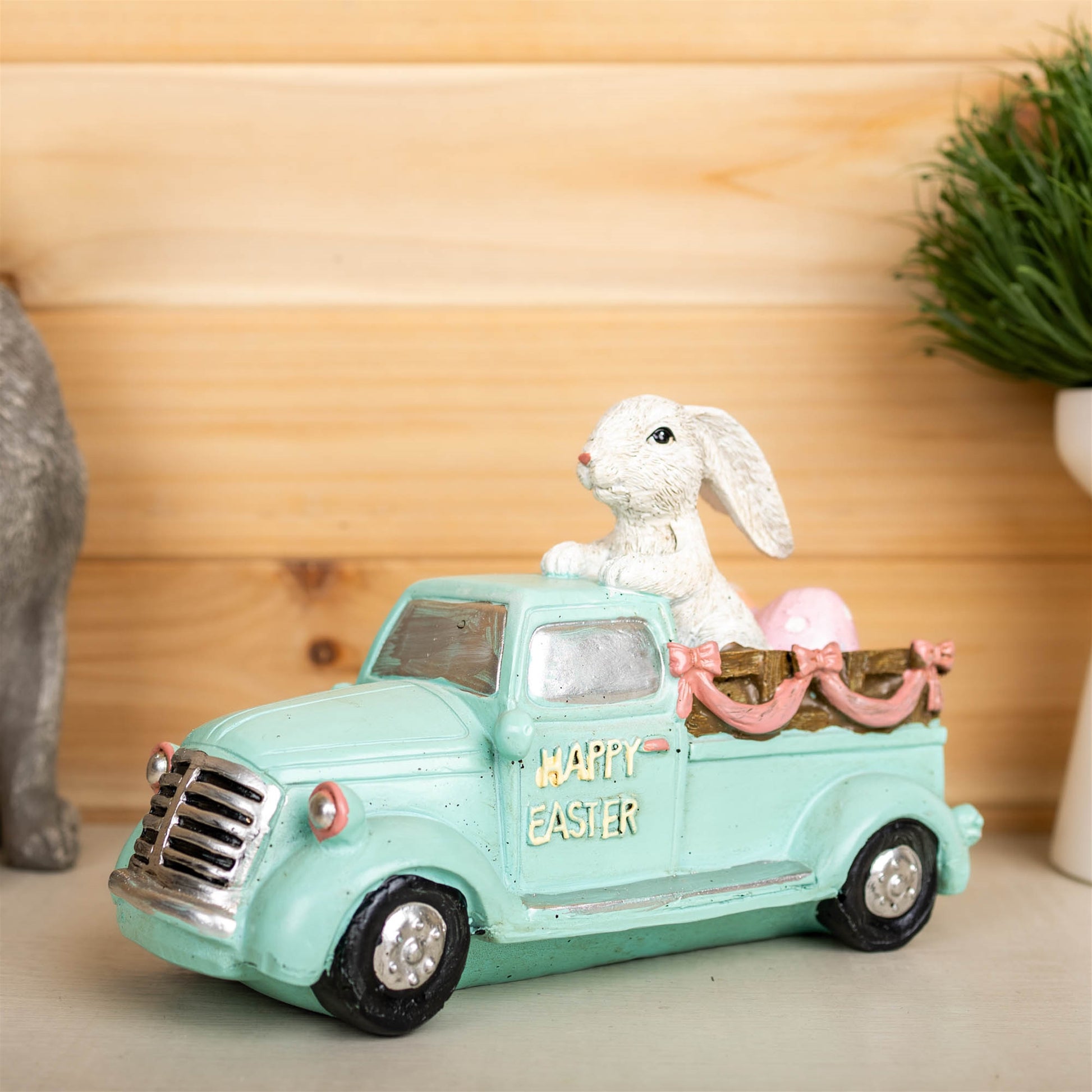 Easter Bunny in a pastel-colored car, crafted from resin, adding a whimsical and colorful touch to home decor.