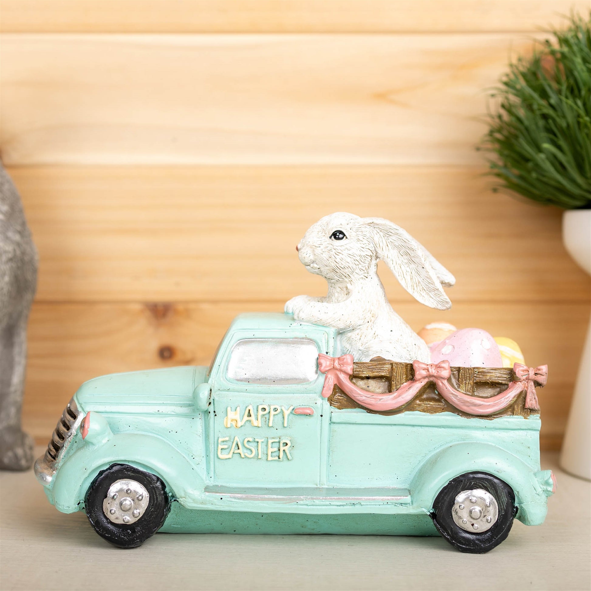 Easter Bunny in a pastel-colored car, crafted from resin, adding a whimsical and colorful touch to home decor.
