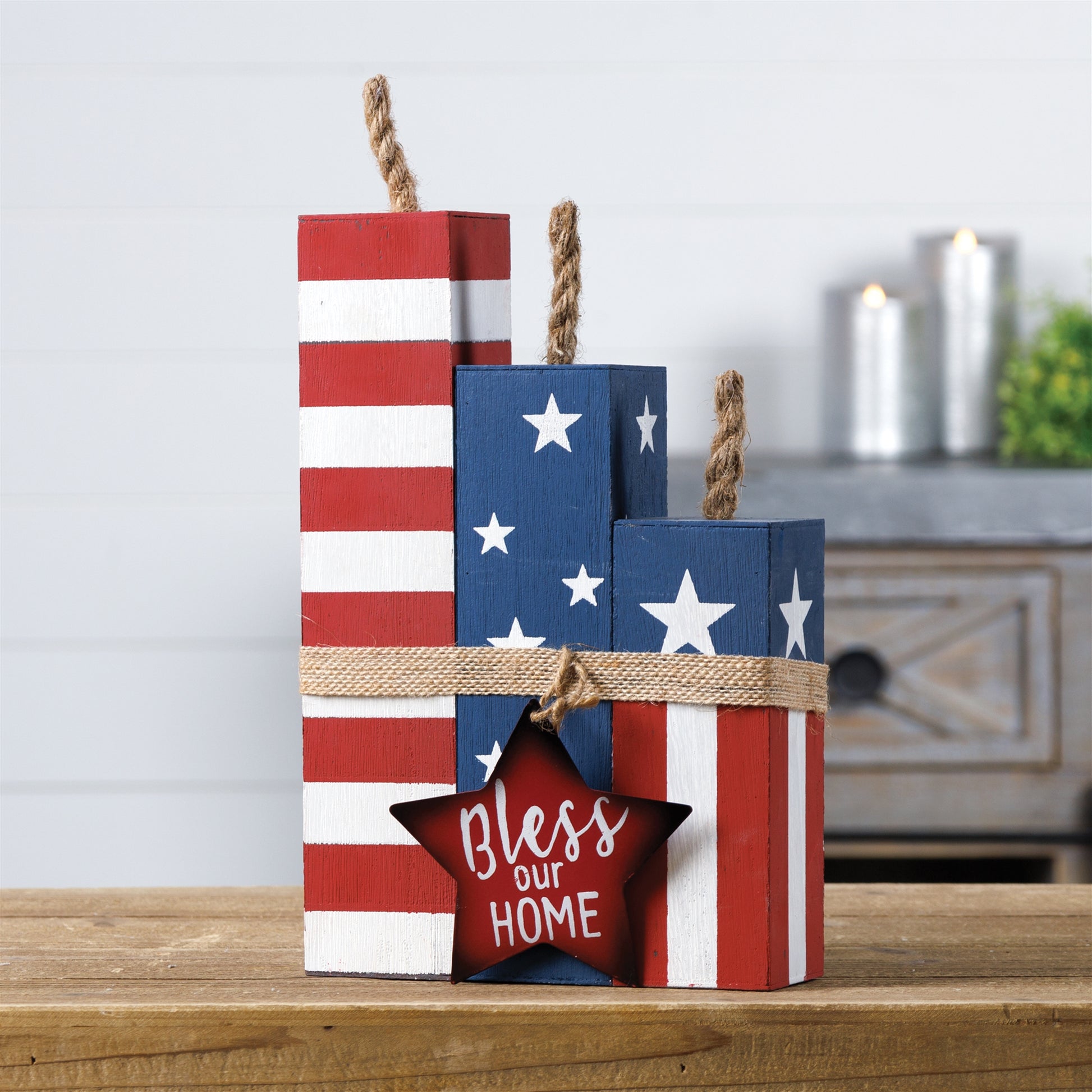 Three rustic wooden blocks in red, white, and blue with "Bless this Home" text, perfect for patriotic decor.