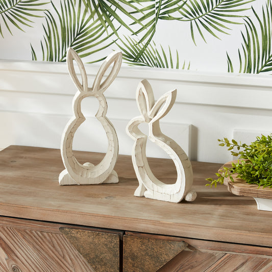 Two carved stone bunny outlines in soft white and grey tones with a weathered finish, perfect for indoor spring decor.