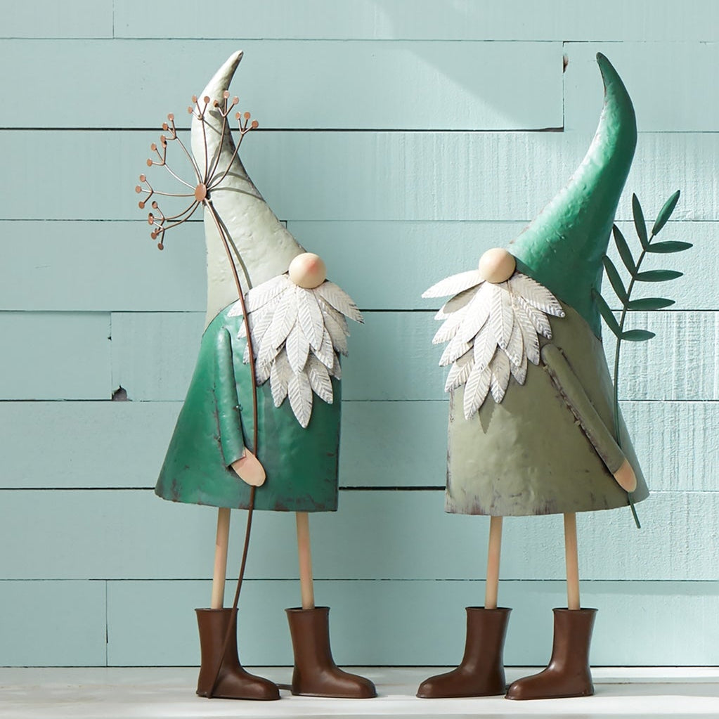 Two vibrant teal iron garden gnomes with rustic metal finish, standing tall on a porch, adding whimsy and color to the space.
