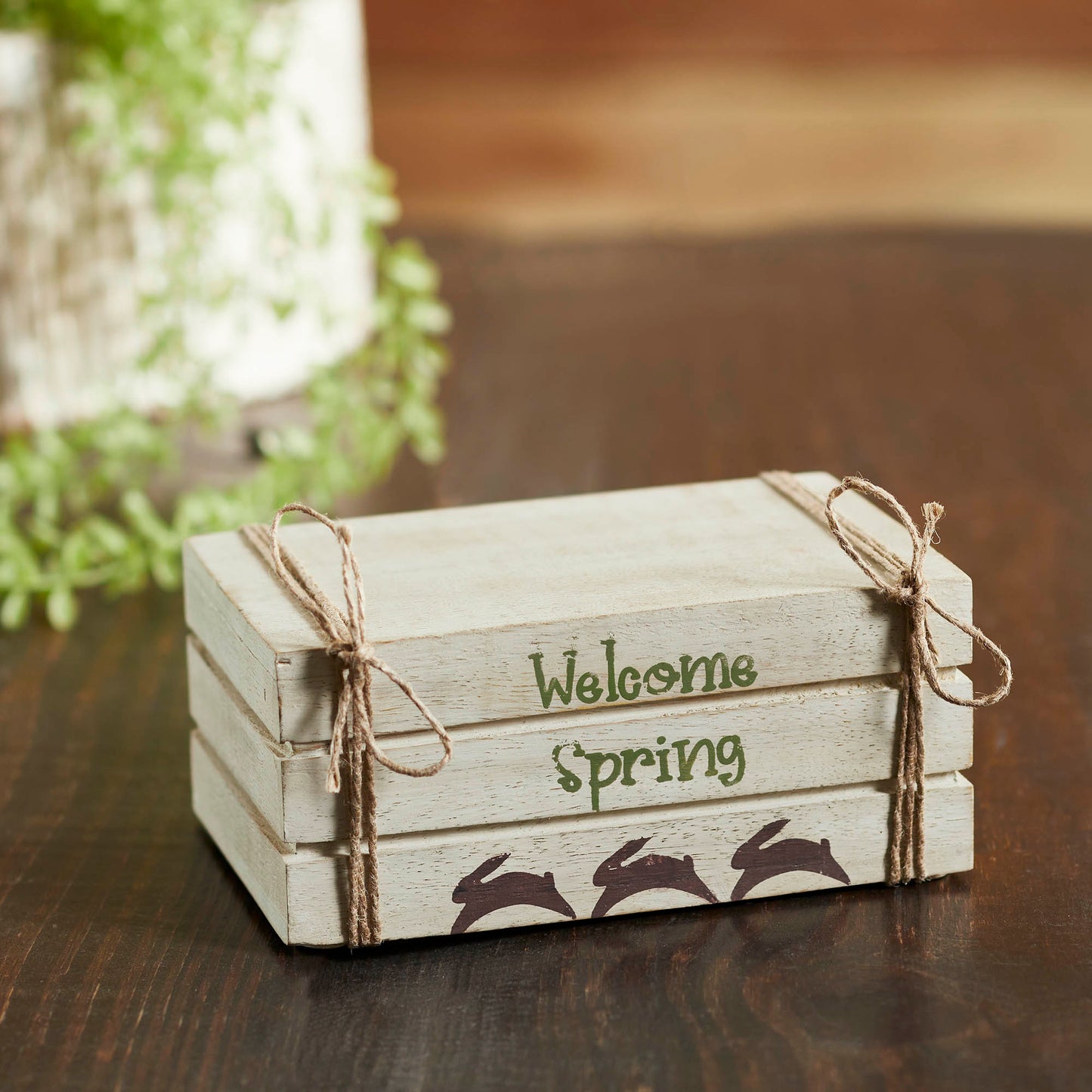 Cream faux book stack decor with Welcome Spring text, hand-painted bunnies, and soft farmhouse spring charm.