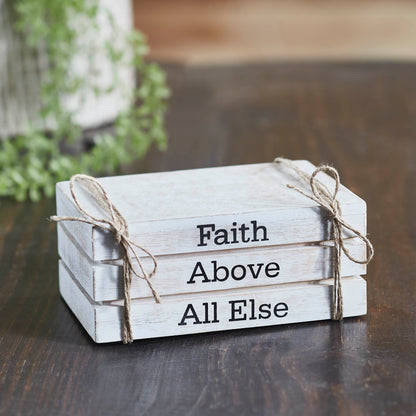 Rustic whitewashed faux book stack with “Faith Above All Else” text, perfect faith-inspired farmhouse decor.