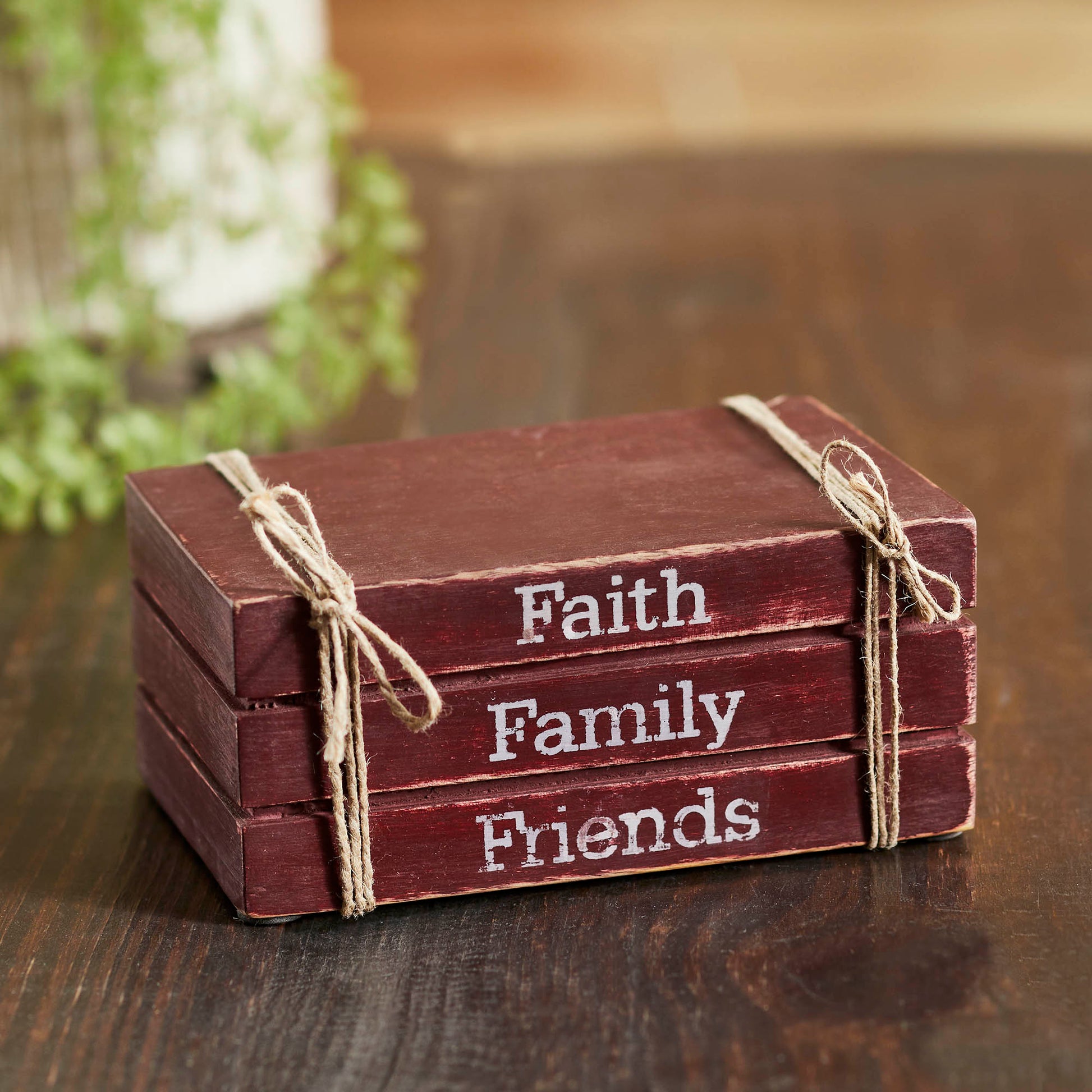Stack of wooden blocks with 'Faith', 'Family', 'Friends' text on a wooden surface.