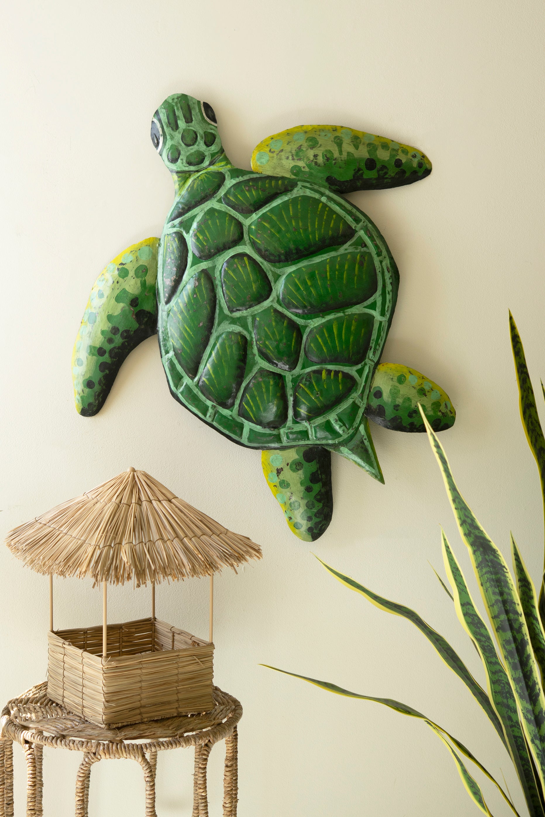 Sea turtle wall sculpture made from recycled metal with a hammered texture, showcasing a sweeping silhouette for coastal decor.