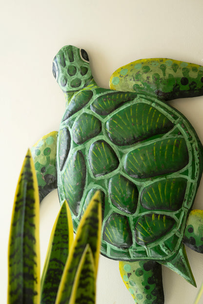 Sea turtle wall sculpture made from recycled metal with a hammered texture, showcasing a sweeping silhouette for coastal decor.