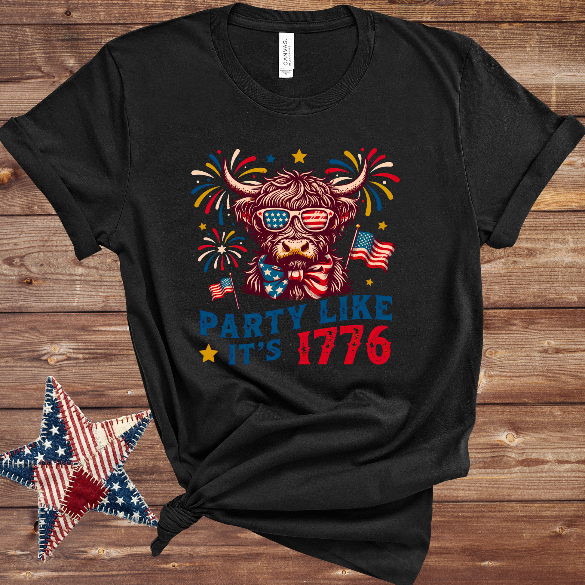 Black Patriotic Highland cow graphic T-shirt with stars-and-stripes bandana in red, white, and blue for Fourth of July fun