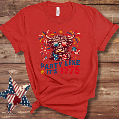 Red Patriotic Highland cow graphic T-shirt with stars-and-stripes bandana in red, white, and blue for Fourth of July fun