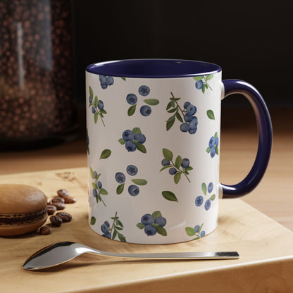 Ceramic mug with blueberry and vine pattern, white exterior, navy interior, and comfortable handle, perfect for farmhouse decor.