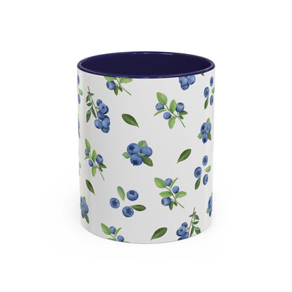 Ceramic mug with blueberry and vine pattern, white exterior, navy interior, and comfortable handle, perfect for farmhouse decor.