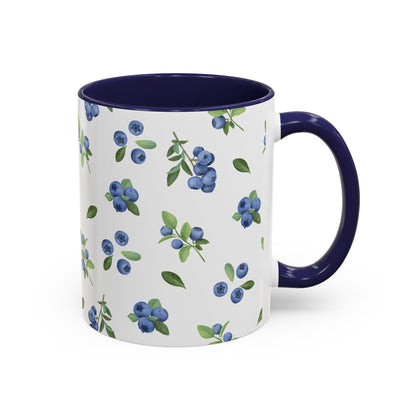 Ceramic mug with blueberry and vine pattern, white exterior, navy interior, and comfortable handle, perfect for farmhouse decor.