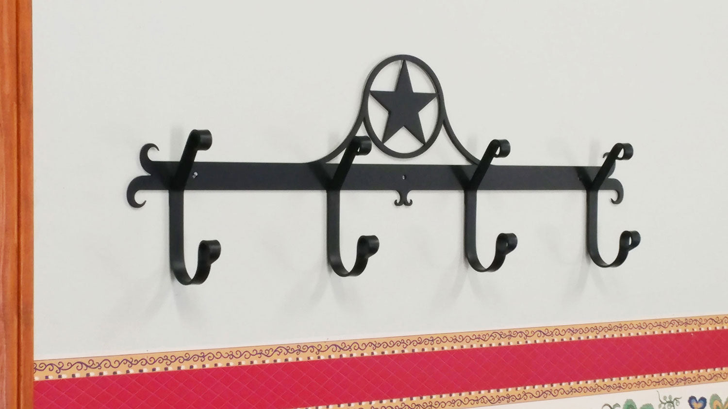 Rustic Western Star Coat Bar with four hooks, featuring a charming design for enhancing farmhouse style in any home setting.